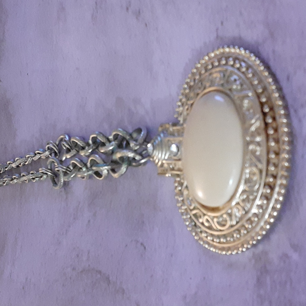 gold and cream color necklace